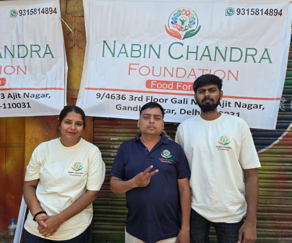 Three NGO members standing together happily